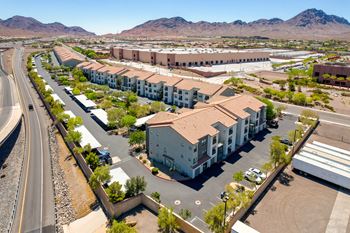 an aerial view of an apartment complex with mountains in the background